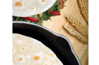 Tortillas in a pan and on table
