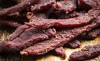 Beef Jerky on a cutting board Beef Jerky on a cutting board