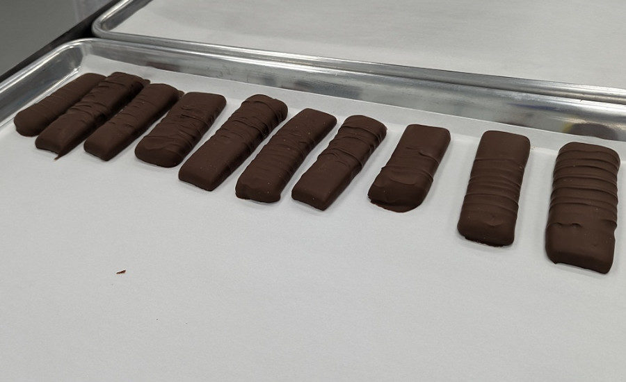 A row of bars consisting of chocolate-enrobe caramel slabs await evaluation in the Prototype Kitchen of the Mars Global Research and Development Hub.