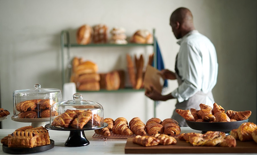 Man with bakery products in a kitchen