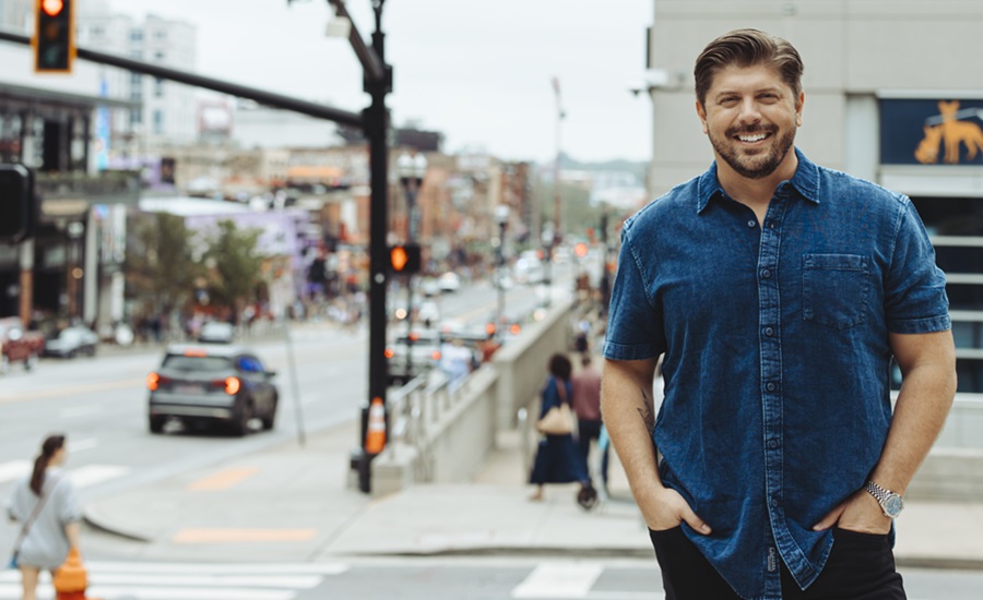 The New Primal founder/CEO Jason Burke standing on the street and looking cool