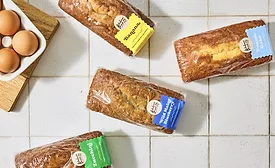 Various loaves of wrapped breads on a table