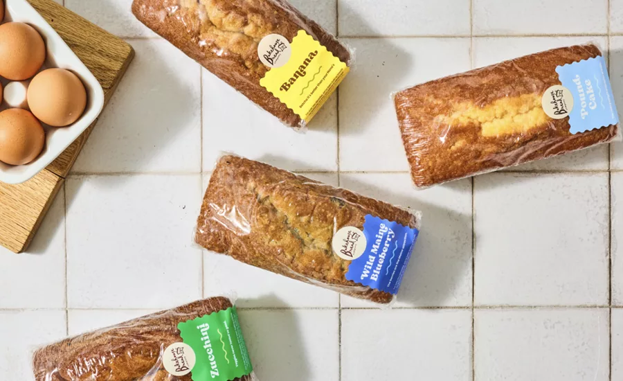 Various loaves of wrapped breads on a table