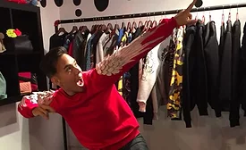 Pic of Olympic skater Apolo Ohno striking a cool pose in a red shirt