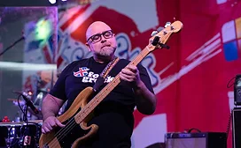 Duff Goldman playing guitar in Foie Grock shirt