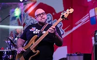 Duff Goldman playing guitar in Foie Grock shirt
