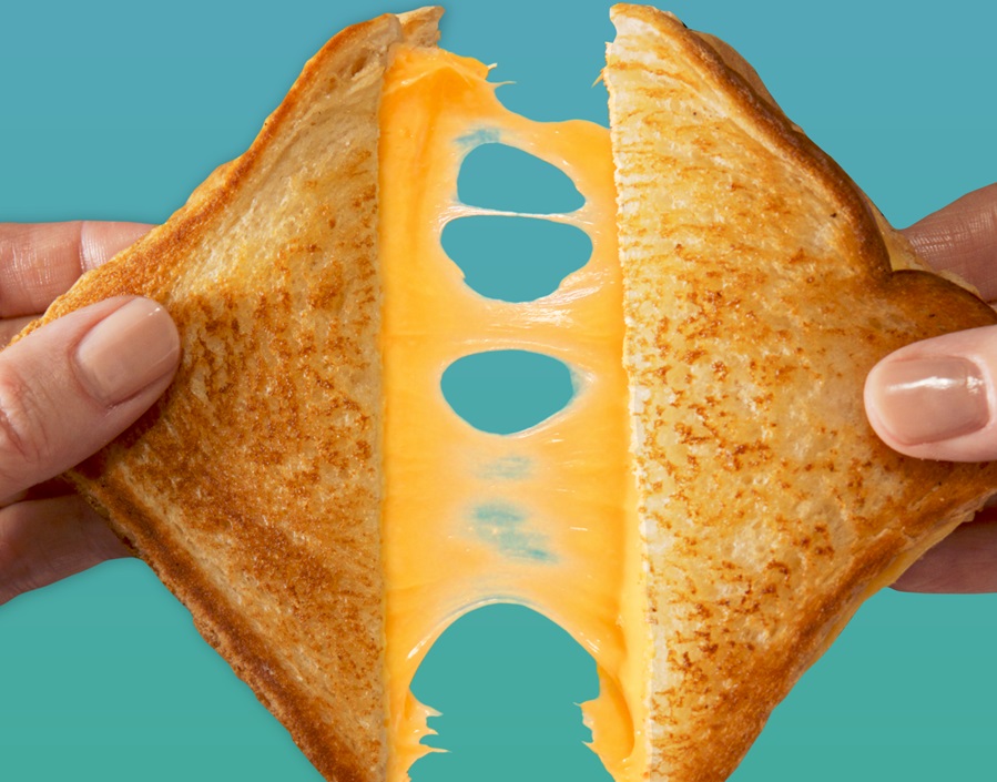 Grilled cheese sandwich being pulled apart