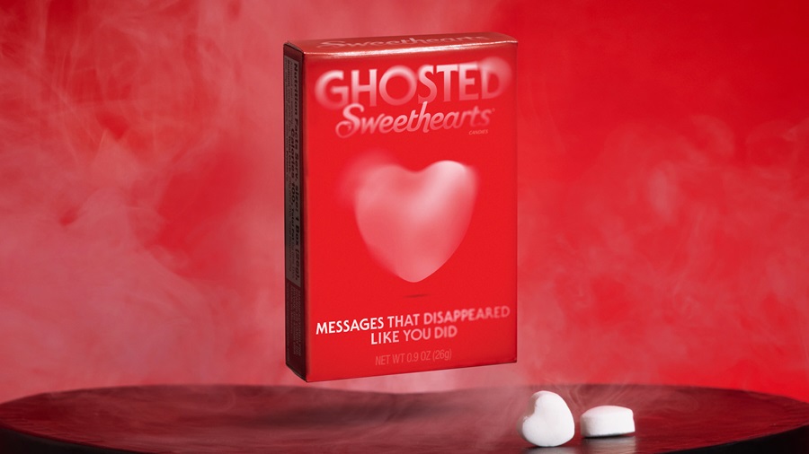Box of red Ghosted Sweethearts candy in front of red background