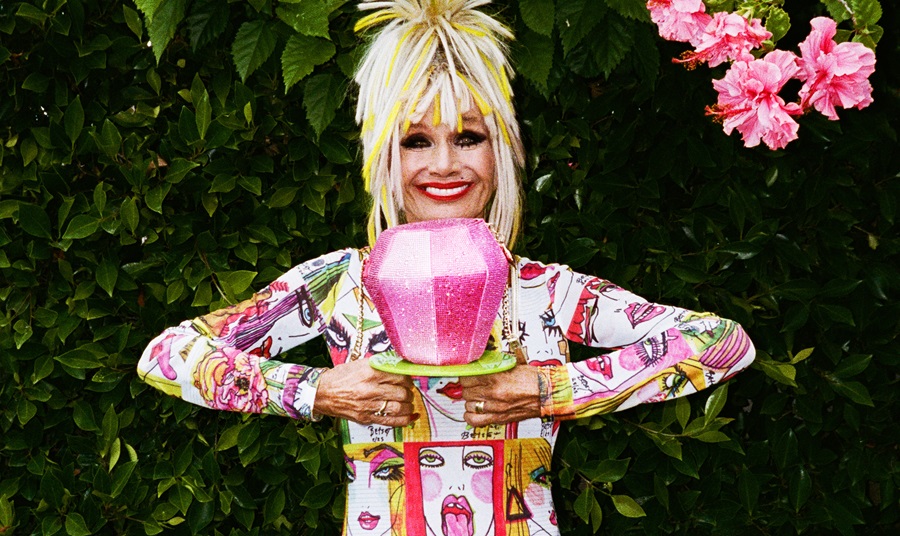 Designer Betsey Johnson holding a Ring Pop bag