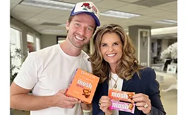 Patrick Schwarzenegger and Maria Shriver holding Mosh bars