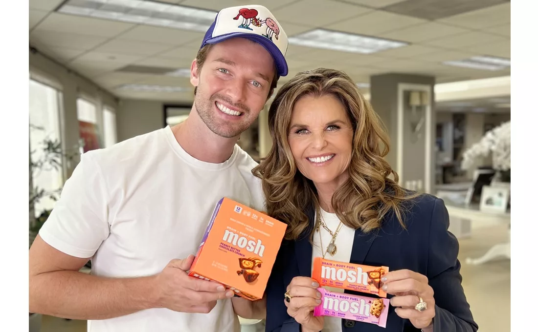 Patrick Schwarzenegger and Maria Shriver holding Mosh bars