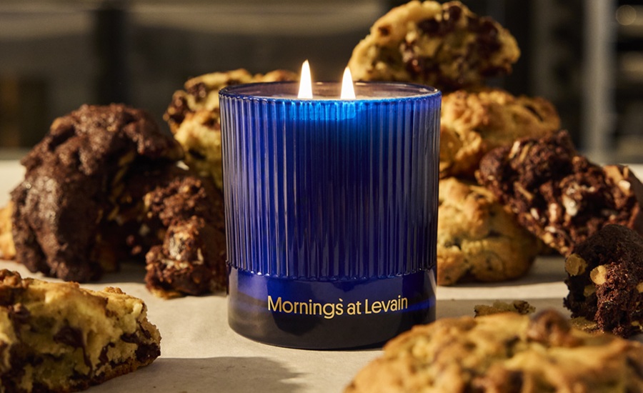 Blue candle burning amid pile of cookies