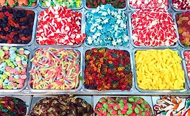 assorted colorful candy gummies on sale at market