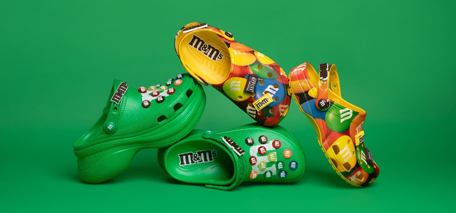 Green and yellow pairs of M&Ms Crocs shoes