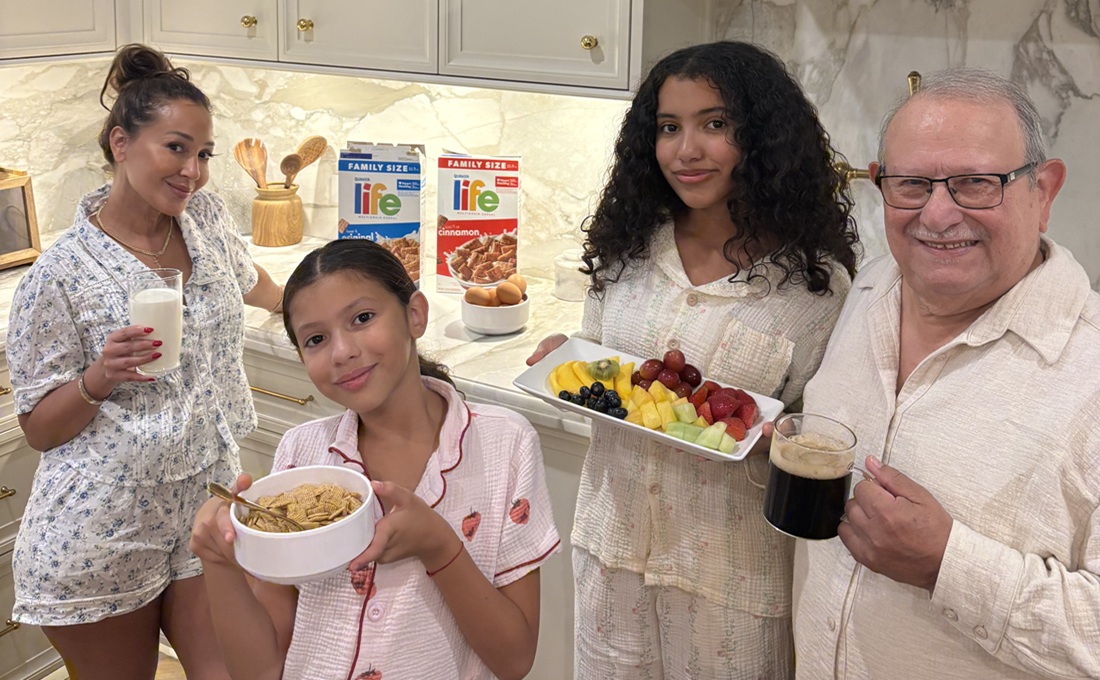 Family in pajamas in kitchen eating Life Cereal