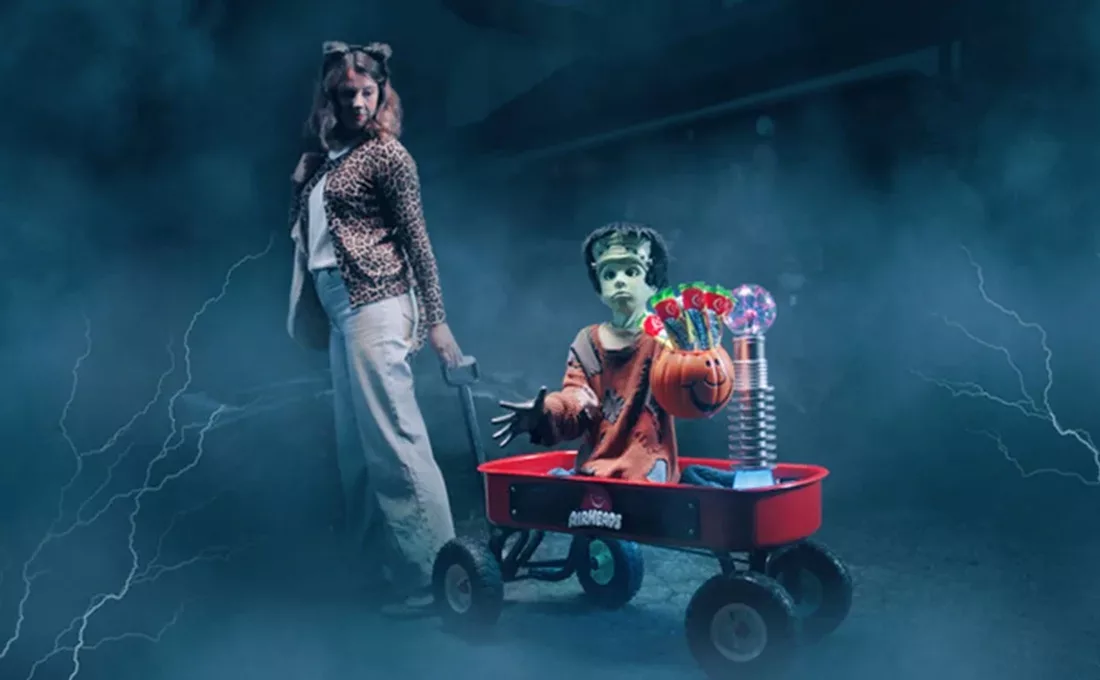 Child robot in Frankenstein costume with adult woman