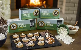 Boxes of Crackerology s'mores kits and tray of snacks