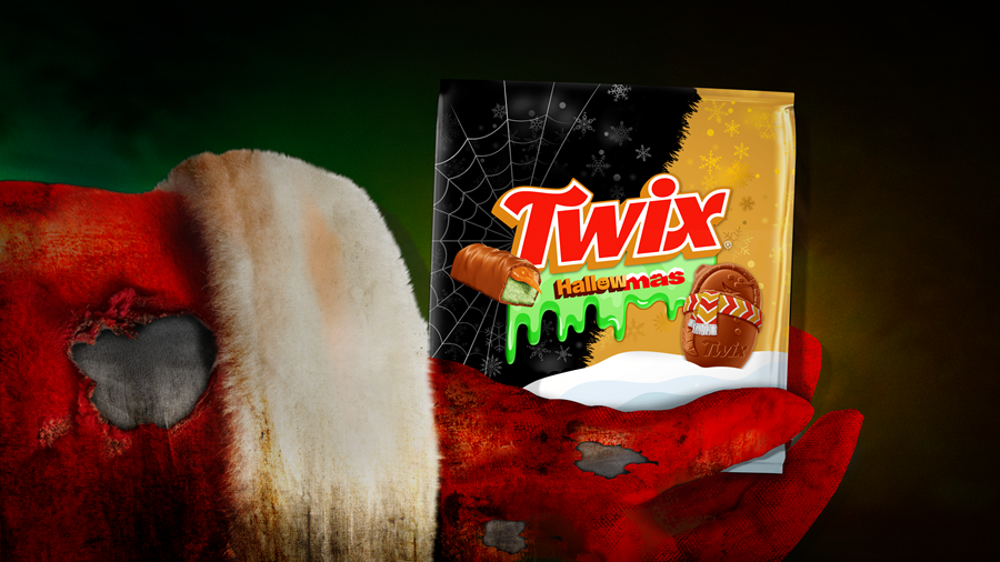 Santa arm holding Twix candy