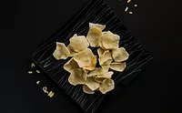pexels-harin-manro-607783-2758893.jpg Crisps on rectangular black plate on a black table