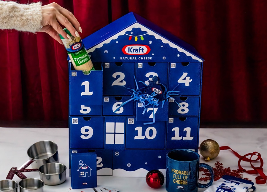 Blue advent calendar with 12 drawers and a hand reaching