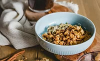 White bowl filled with granola on a table