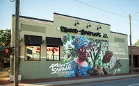 Hu_Mural.jpg Mural on building featuring colorfully dressed African woman