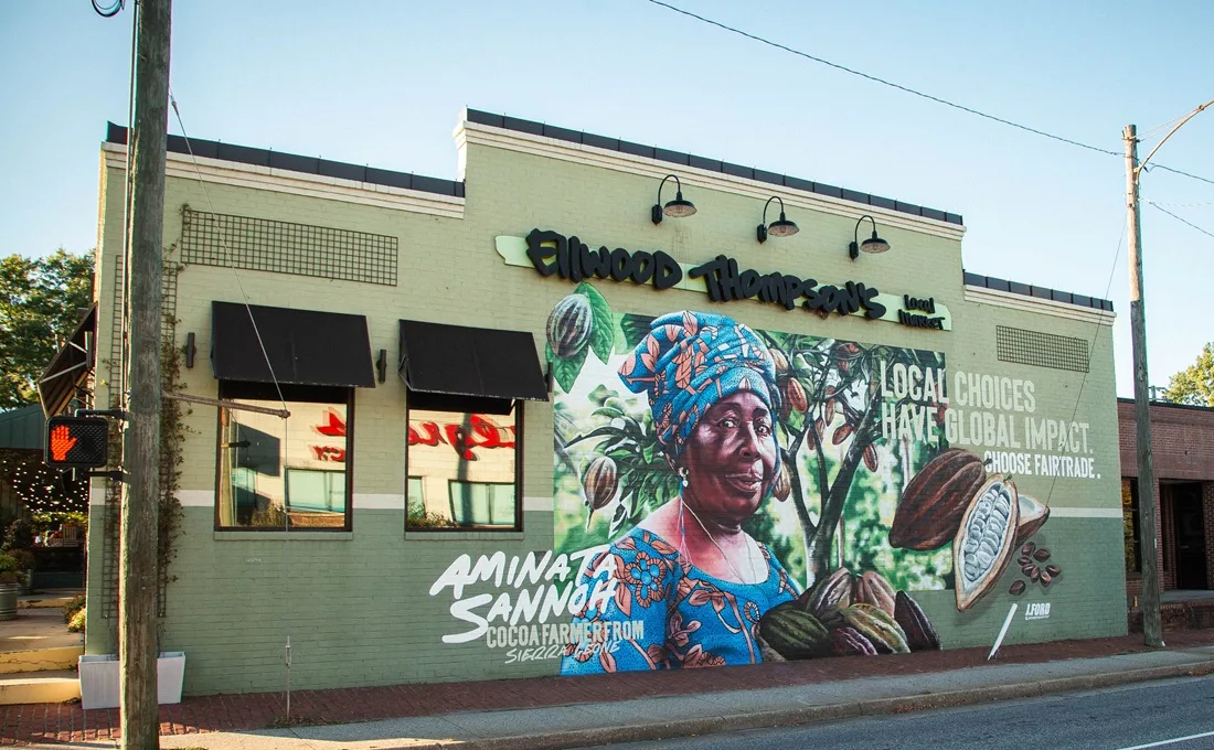 Mural on building featuring colorfully dressed African woman