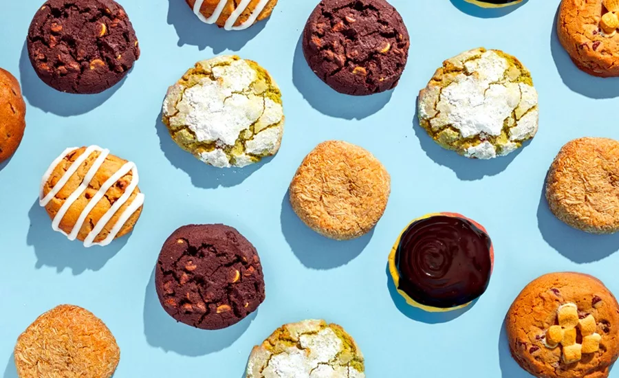 Assorted premium cookies on light blue background