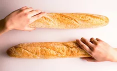 Hands holding two parallel mini baguettes