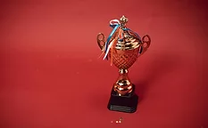Trophy and ribbons on red background