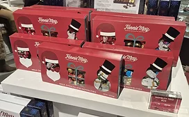 Red decorated boxes of Fannie May chocolates on a shelf