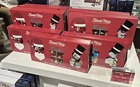 FMholiday_lead.jpg Red decorated boxes of Fannie May chocolates on a shelf