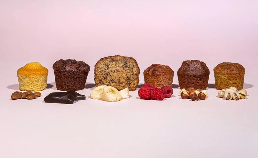 Line of assorted cakes on a pink background