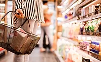 NonGMO_upf.jpg Woman shown from the neck down holding grocery handbasket