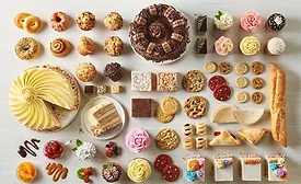 Table full of cakes, cookies, and other baked goods