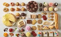 Table full of cakes, cookies, and other baked goods