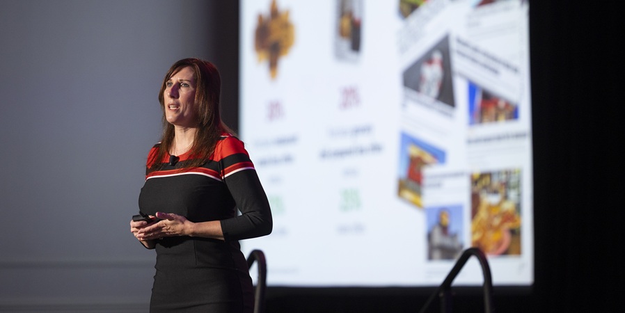 Anne-Marie Roerink of 210 Analytics in front of presentation screen