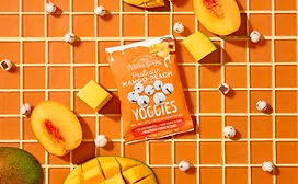 Pouch of Nature's Garden fruit snacks on decorated orange table