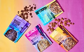 Four pouches of Magic Spoon granola over multicolored background
