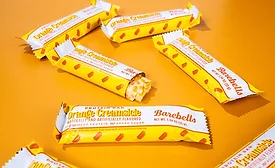 Several Barebells Orange Creamsicle bars on orange background