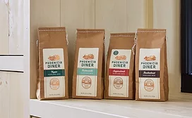 Four pouches of Phonicia Diner pancake mix on white counter