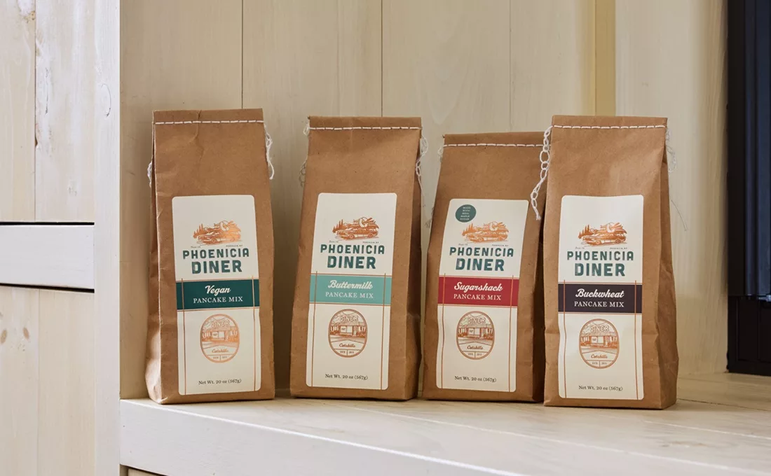 Four pouches of Phonicia Diner pancake mix on white counter