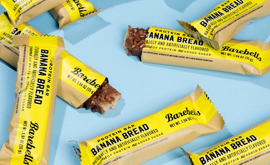 Bunch of Barebells Banana Bread bars on blue background
