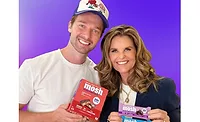 Patrick Schwarzenegger and Maria Shriver holding Mosh bars