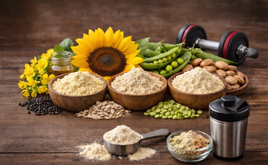Wooden table holding sunflower, flour, and other ingredients