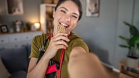Smiling women eating a snack bar