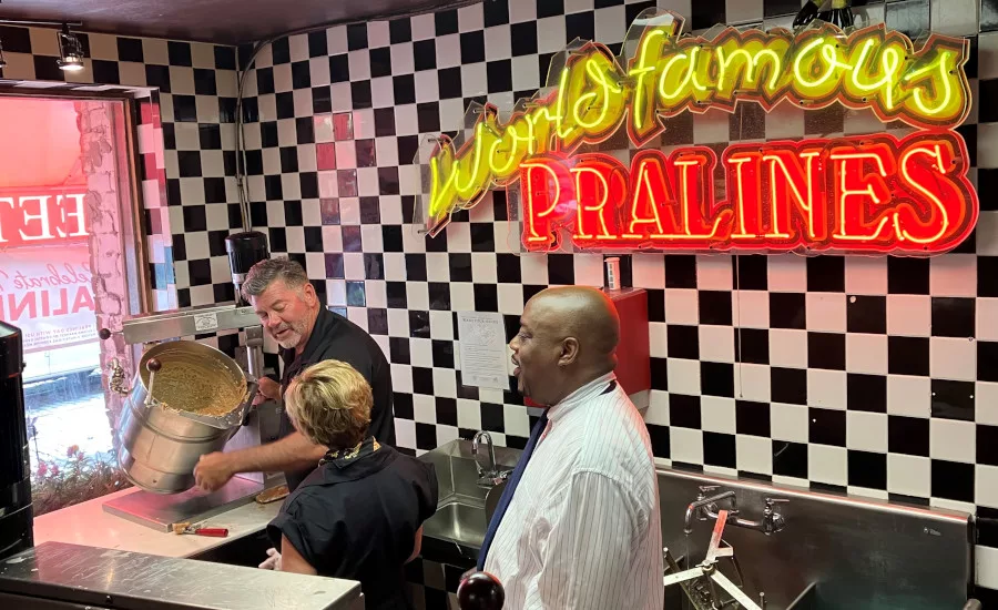 Tim Showing Mary Jane and Mayor Johnson The Art of Scooping Pralines