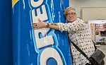 Editor Jenni Spinner on the show floor hugging an Oreo mascot