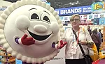 Editor Jenni Spinner on the show floor posing with a Crustables mascot