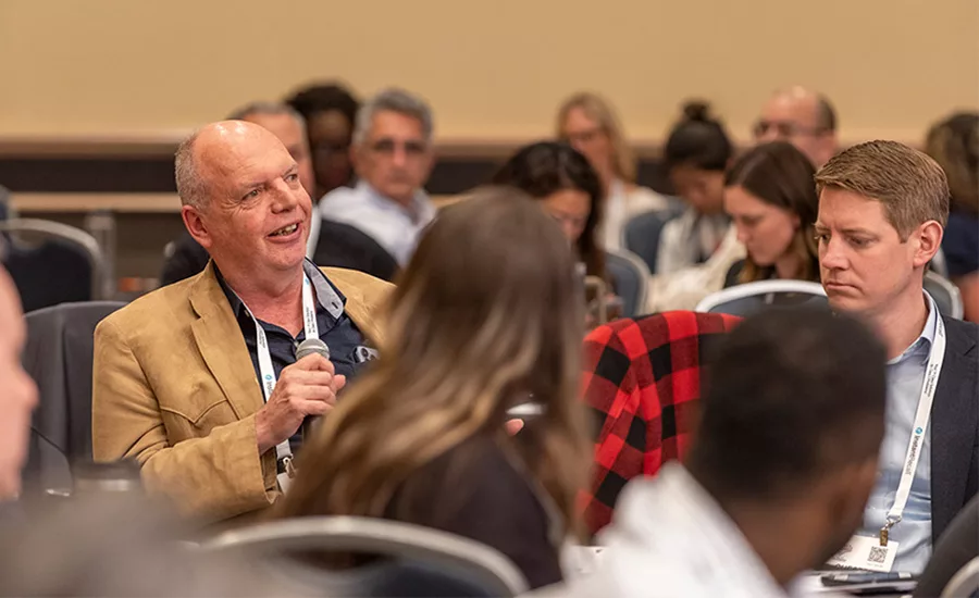 man speaking at the summit